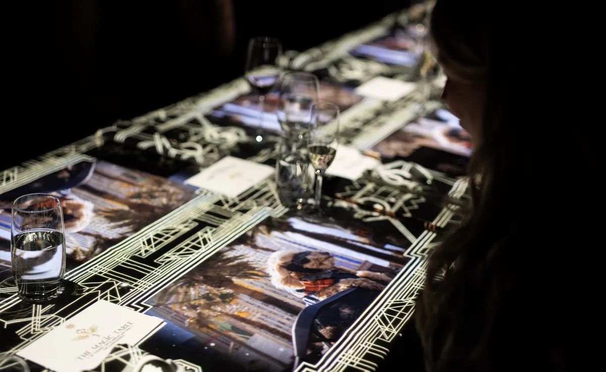 The Magic Table Bangkok — guests at the magical illuminated table